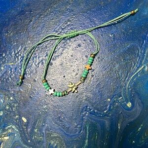 Butterfly stones cross bracelet and green beads with adjustable cord